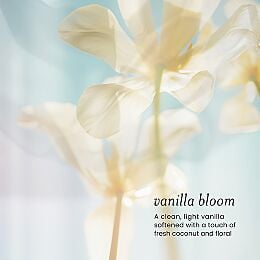 Soft-focus vanilla bloom flowers with text describing the Drybar Detox Silk fragrance featuring light vanilla, fresh coconut, and floral notes.